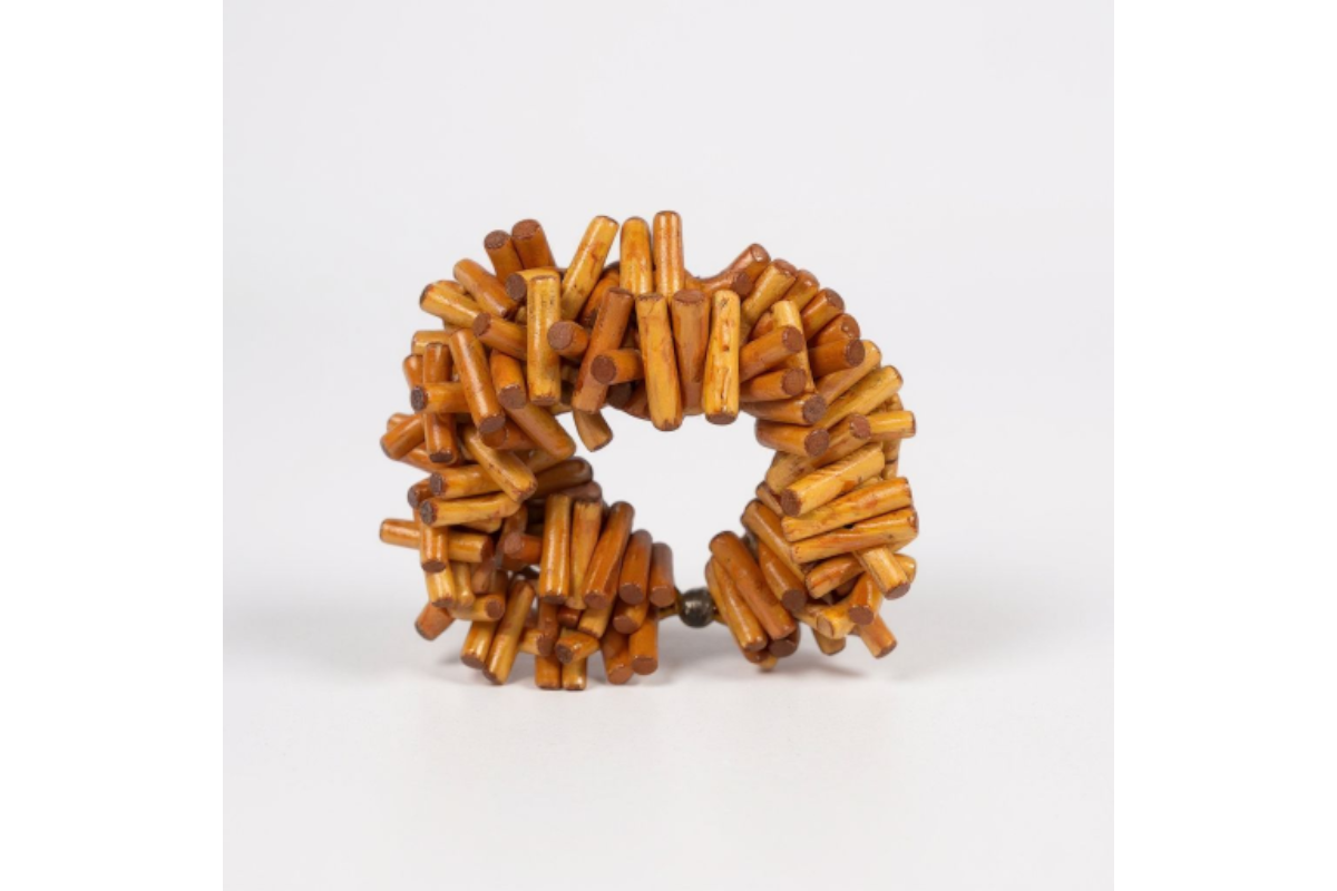 Uncompromised Bracelet with layered natural beads and signature leaf charm, a statement piece for bold sophistication.