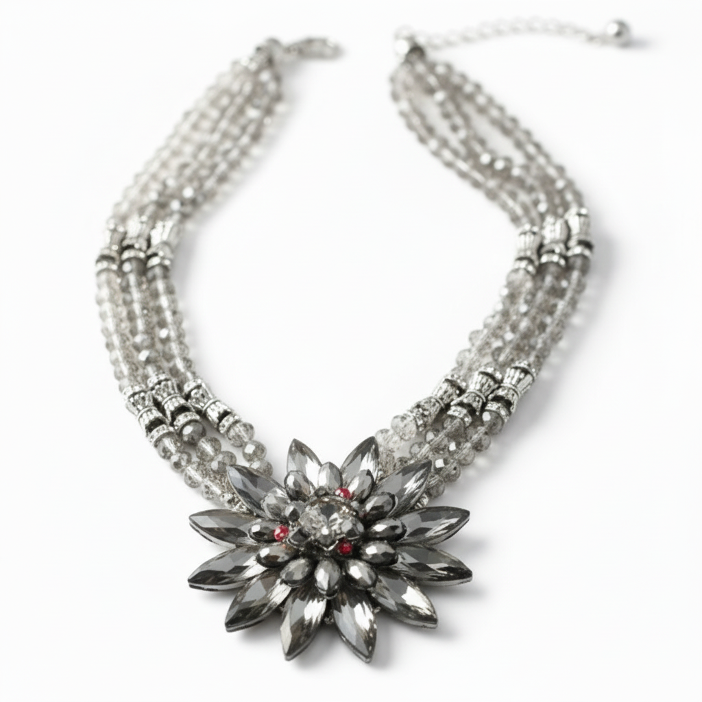 Chunky handmade statement necklace featuring faceted gunmetal silver beads and an oversized silver snowflake pendant with vintage brushed silver hardware and lobster claw clasp._ZOHARAS VOGUE