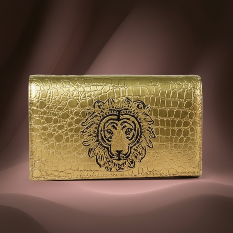Gold crocodile-embossed clutch with lion motif from ZoharaVogue