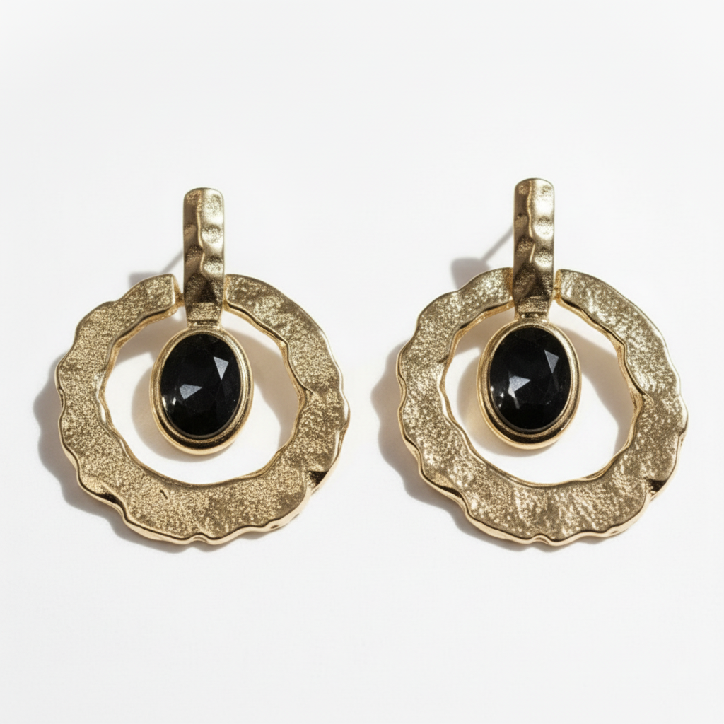 Pair of gold earrings with black gemstones on a white background ZoharasVogue 