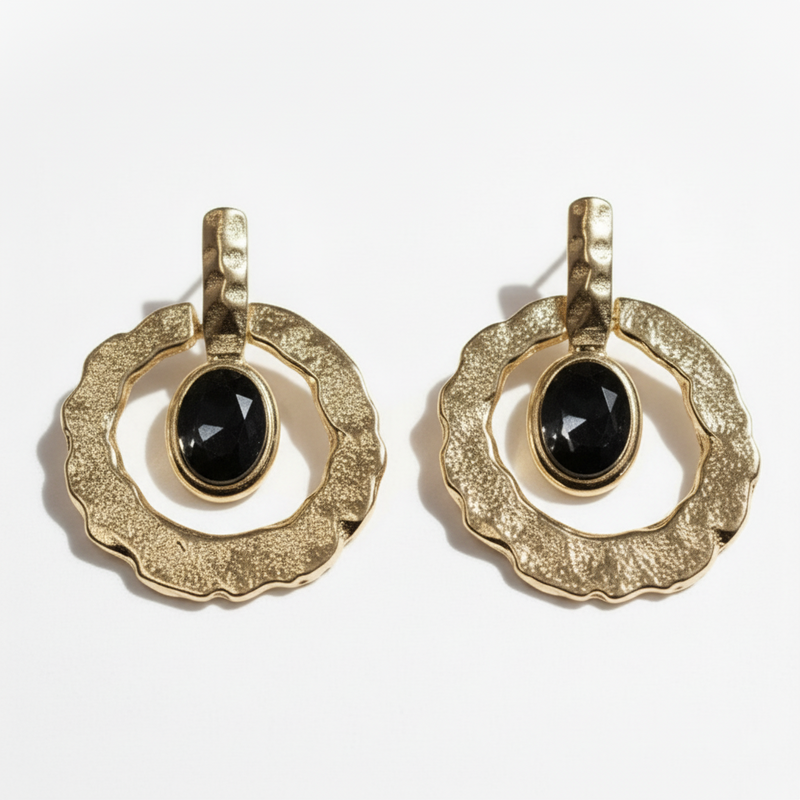 Pair of gold earrings with black gemstones on a white background ZoharasVogue 