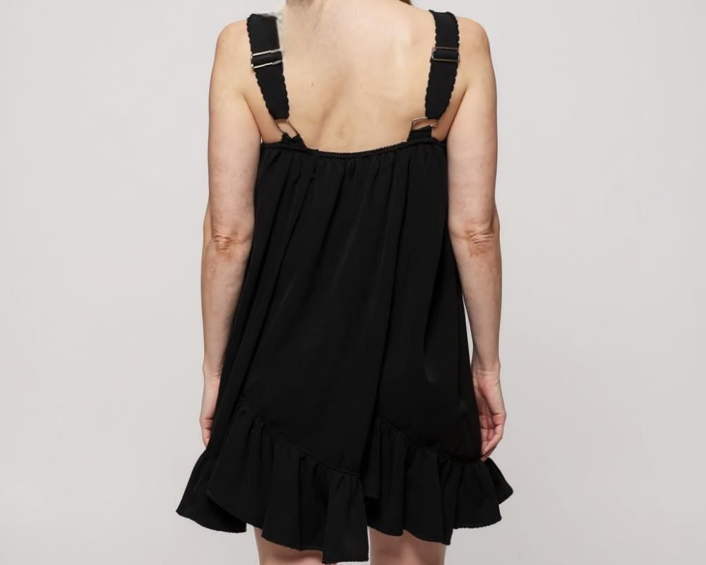 black sleeveless dress is designed to flatter with its clean square neckline and adjustable shoulder straps for a customized fit. Crafted from lightweight, breathable fabric, it drapes gracefully into a relaxed, knee-length silhouette that moves with ease. ZoharasVogue 