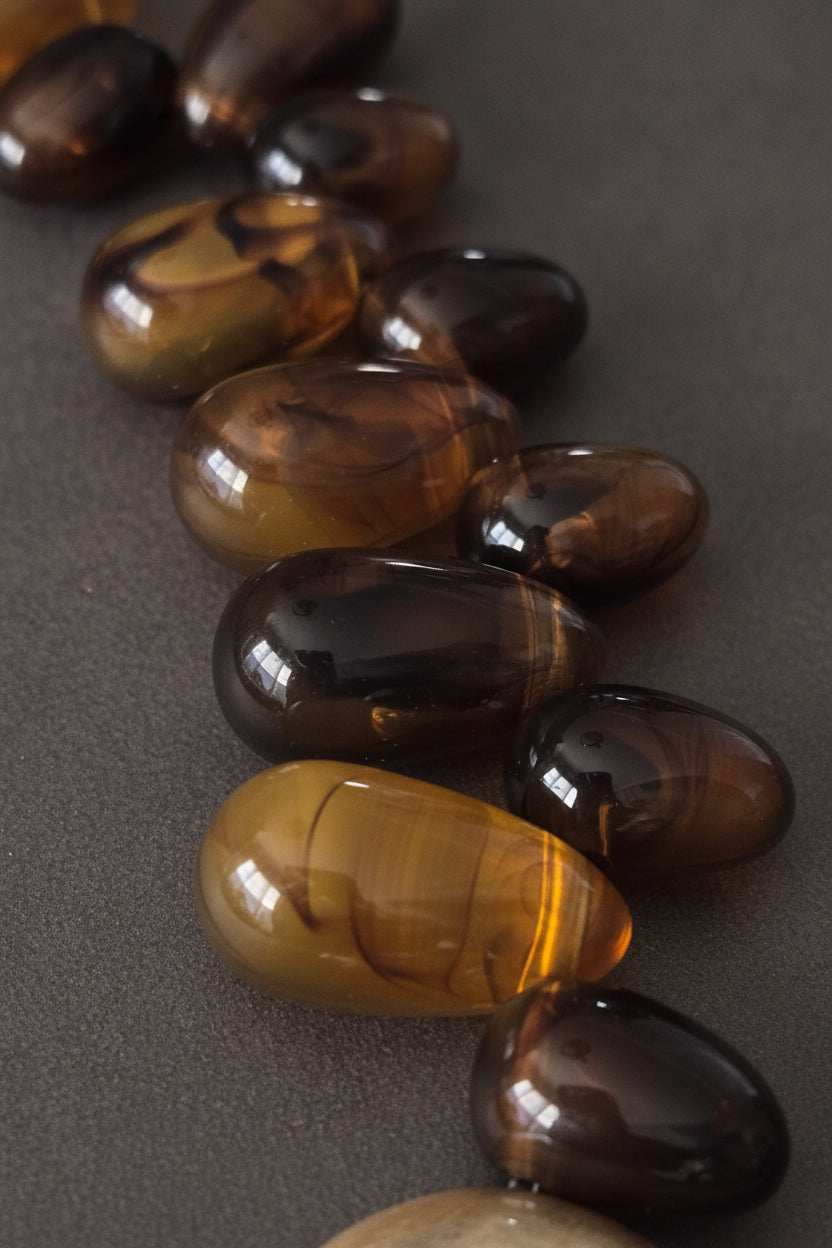 bold amber-toned statement necklace with layered beads and a textured oversized 