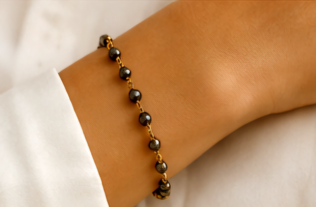 The Eclipse Necklace Handcrafted pyrite gemstone necklace and bracelet featuring faceted rondelle beads, gold chain links, and an open circle pendant in a modern luxury design.- ZOHARAS VOGUE
