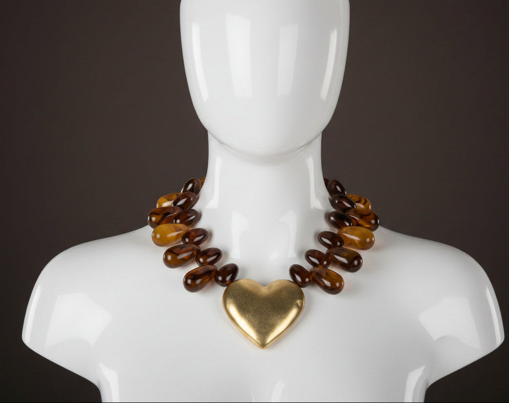 bold amber-toned statement necklace with layered beads and a textured oversized 