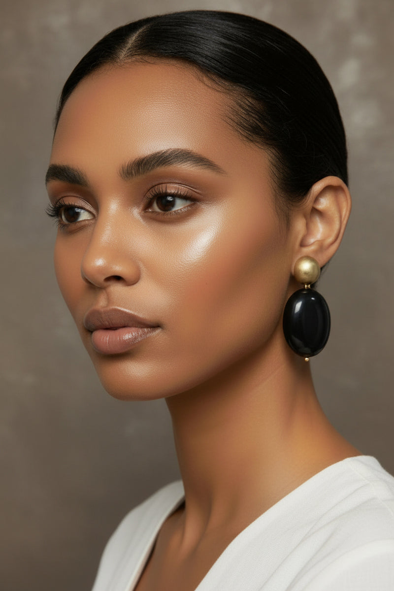 The Dior Statement Earrings, model wearing a chunky beaded necklace with alternating black and matte gold beads on a marble surface. ZoharasVogue
