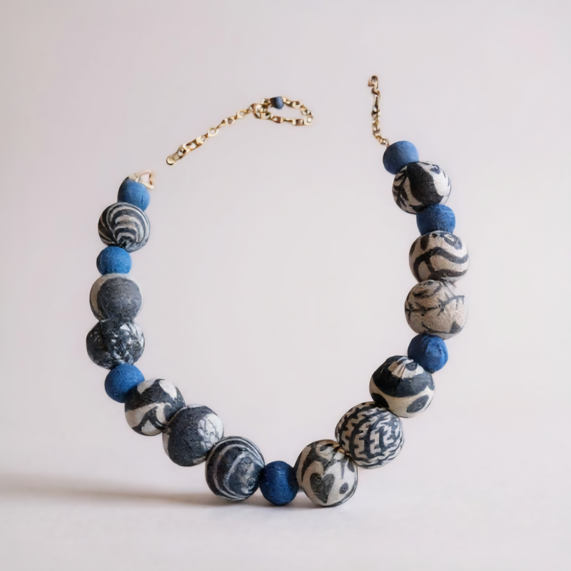 Handmade indigo and black-and-white Kantha beaded necklace with alternating bead sizes and collar-style fit.